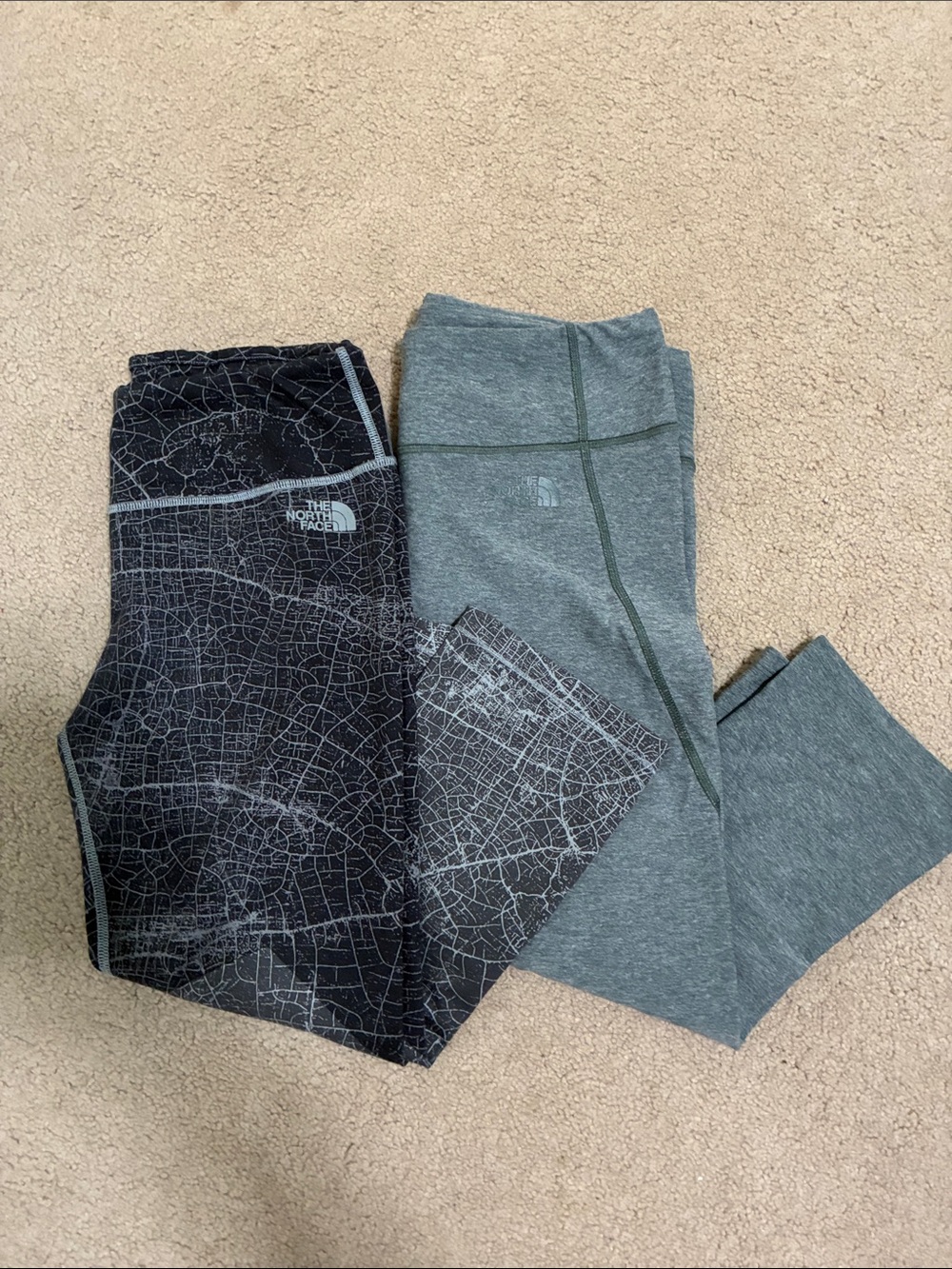 Two pairs of North Face women’s capris in black and grey